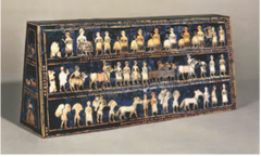 16. Standard of Ur
Location: Royal Tombs at Ur (modern-day Tell el-Muqayyar, Iraq
Artist: N/A
Date: 2,600-2,400 B.C.E
Culture: Sumerian
Period/Style: Ancient Near East
Medium/Material: Wood inlaid with shells, lapis lazuli, and red limestone
Theme(s): war, peace, migration
Form: A trapezoidal prism that uses color, lines, and shape to show and describe times of peace conflict.
Function: likely to have been the sound box for a musical instrument. 
Content: The war side shows representations of a Sumerian army. Chariots, each pulled by four donkeys, trample enemies; infantry with cloaks carry spears; enemy soldiers are killed with axes, others are paraded naked and presented to the king who holds a spear. The peace panel shows animals, fish and other goods brought in procession to a banquet. 
Context: found in one of the largest graves in the Royal Cemetery at Ur, lying in the corner of a chamber above a soldier who is believed to have carried it on a long pole as a standard, the royal emblem of a king.