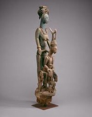 180: Veranda post: equestrian figure and female caryatid
Location: ?
Artist: Olowe of Ise
Date: before 1938 C.E
Culture: Yoruba peoples, Ekiti group
Period/Style: ...
Medium/Material: wood & pigment
Theme(s): marriage importance (first wife), hierarchy of scale
Form: an equestrian warior, is depicted frontally above a female caryatid with arms raised in three-quarter view; first wife is larger than other 2
Function: designed for the exterior courtyard of a Yoruba palace
Content: mounted warrior holds a spear and pistol in either hand, and his vest, saddle, and horse's headgear are articulated through deeply carved linear motifs
Context: In Yoruba art such equestrian figures identify their patrons with martial conquest achieved through physical might.
Cross Cultural Connection(s):