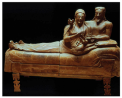 29. Sarcophagus of the Spouses
Location: Cerverteri, Italy
Artist: N/A
Date: c. 520 B.C.E.
Culture: Etruscan
Period/Style: Archaic period
Medium/Material: terracotta
Theme(s): freedom, death
Form: shape, form, and value add up to each other to allow for lighting differences.
Function: Sarcoughagus containing the ashes of the deceased; funerary monument
Content: Detail in hair color; portrayed women's relative freedom in Etruscan society; terracotta, funerary monument, sarcophagus, gender relations/ gender roles, expressive figures, unrealistic proportions
Context: The couple are lounging on a banquet couch for what might be a funeral banquent for the dead.