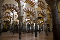 56. Great Mosque
Location: Córdoba, Spain
Date: c. 785-786 C.E., eighth-tenth centuries
Period/Style: Umayyad Caliphate (Islamic Art)
Medium/Material: Stone masonry
Theme(s): worship
Form: Double-arched columns, articulated in alternating bands of color; voussoirs
Function: worship
Content: columns are spoil, hypostyle mosque, kufic calligraphy, complex dome over mihrab (squinches) 
Context: ...
Cross Cultural Connection(s):