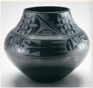 Black-on-black ceramic vessel. Maria Martinez and Julian Martinez, Tewa, Puebloan, San Ildefonso Pueblo, New Mexico. mid-20th century. Blackware ceramic. 
-black on black vessels
-highly polished surfaces
-contrasts of shiny and black and matte black finishes
-comes from the 1000 year old tradition of pottery making in the southwest
-at the time pueblos were in decline, with modern life replacing traditional
-Their work sparked a revival of the techniques
- Maria made them and Julian painted them
-exceptional symmetry