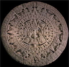 Calendar stone
-it was the conception of time for the Aztec
- In the center there is the image of the Fifth Sun, Nahui Olin or Four Movement and the face of Tonatiuh, god of the Sun, with the particular representation of having only the lower half of the face fleshless and the upper part normal, which symbolizes life and death
-The mythology is that life has gone through different eras of creation and destruction
- placed on the floor on the temple site 
-its multiple rings symbolize different things
- used as an alter to sacrifice people
- tongue in the center of the stone coming from the god's mouth was a sacrificial flint knife used to slash open the victims