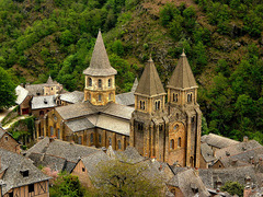 Church of Sainte Foy Exterior 

Conques, France, Romanesque, 1050-1130, stone

Church built along the pilgrimage site to the Santiago de Compostela 
Church built to handle large number of people coming to view the relics housed there, has wide transept, large ambulatory and many radiating chapels
Massive heavy unornamented interior walls
No clerestory as barrel vaults were too heavy and required too much butressing so no room, but light provided by windows over side aisles and galleries
Barrel vaults fill the nave, reinforced by various transverse arches
Cross like ground plan
