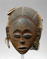 Female (Pwo) mask. Chokwe peoples (Democratic Republic of the Congo). Late 19th to early 20th century C.E. Wood, fiber, pigment, and metal.
