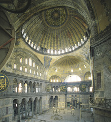 Hagia Sophia Interior

Constantinople Anthemius of Tralles and Isidorus of Miletus 523-537 C.E., Brick/Ceramic elements with stone and mosaic veneer 

Commisioned by Justinian showing his power after the Nike Revolt of 532
Combo of centrally planned church and axial planned basilican church
Exterior is plan yet massive 
Central dome made with no supports beneath it done by using pendentives supported by large piers
Half domes to each side of the main dome helps spread out the weight
40 windows placed at bottom of domes making it seem like they are floating
Large gold mosaics once covered the walls
Marble brought from across the empire
Minarets added during the islamic period when building made into a mosque