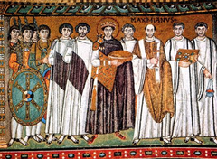 Justinian, Bishop Maximianus and attendants.Head cluster.Stand in for Justinian- was never in Ravenna.12 attendants for 12 apostles.No separation of church and state. Shows Imperial guards to left with Christ's monogram on shield; imperial attendants; clergy.Stiff, frontal figures. right is military. royal purple and gold. a shallow bowl for eucharist. procession forward.
