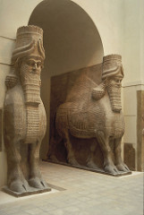 Lamassu from the citadel of Sargon II, Dur Sharrukin
Neo-Assyrian. c. 720-705 B.C.E. Alabaster
-Guardian figures that protected the citadel (temple & palace)
-Fierce & powerful, symbolizes the king
-Inscriptions in cuneiform articulate the power of the king and damnation of those who don't obey him
-Assyrians were one of the first to create grand arches and entrances (opposite of the Greeks, similar to the Romans) that were more structurally sound since weight is distributed out to surrounding the walls

1. The Lamassu were guardian figures that stood at the gateways to the city and its citadels. It would have been impossible to approach the citadel without seeing them. (2.1A)
2. They were created at the height of Assyrian civilization. They were an expression of the power of the Assyrian king. They are comparable to Sphinxes in the Egyptian tradition. (2.1B)
3. The perspective of the Lamassu is different depending on where someone views it. From the side, the legs appear to be walking with the viewer and is welcoming. From the front, the figure is static and formidable. (2.1)
4. The face of the Lamassu has wavy hair, connected eyebrows, earrings, and an elaborate beard. The wings form a decorative panel which show power and prestige. (2.1)
5. The figure is carved out of a monolithic stone. There are inscriptions that talk about the power of the Assyrian empire. (2.1A)