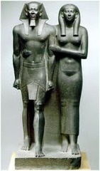 *Menkaure and His Queen*
2490-2472 BC
Old Kingdom
Gizeh, Egypt
Slate

Statues are wedded to their pedestal. Rigidly frontal. The couple shows no sign of emotion or affection for each other. He wears a nemes