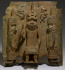 Name: Wall Plaque of Oba's Palace

Date: 1600 CE

Medium: Cast brass and ivory

Location: Benin City, Nigeria (South/Mid Western Nigeria)

Artist: Edo People

Form: Hierarchy of scale, relief sculpture

Function: To display the king's power

Content: King Oba standing in the middle with attendants kneeling beside him with two tiny Portuguese traders in the back, Portuguese are non human looking

Context: It is the people's obligation to assist the king with whatever he needs, whenever he needs it