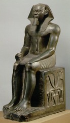 Seated Statue of Khafre
c. 2500 BCE; Old Kingdom
Culture: Egypt
Falcon god horus is behind Khafre's head. no negative space between arms and legs. Pharaoh is idealized. Symbol of a united Egypt in the interlocking of lotus and papyrus plants at the base. Strict adherence to Egyptian canon of proportions.