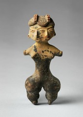 Tlatilco Female Figurine
Central Mexico, 1200-900 B.C.E.
Ceramic
Emphasis on wide hips and legs with a narrow waist symbolizing fertility
Double faced with two noses mouths etc. but only three eyes
Elaborate hairstyle depicted with incising of clay
Relates to concept of duality within people in Mesoamerica
Possible shamanistic function
Societies now sedentary allowing specialization of labor and products like this to be made
Foreshadowed the art of great civilizations in the area to come